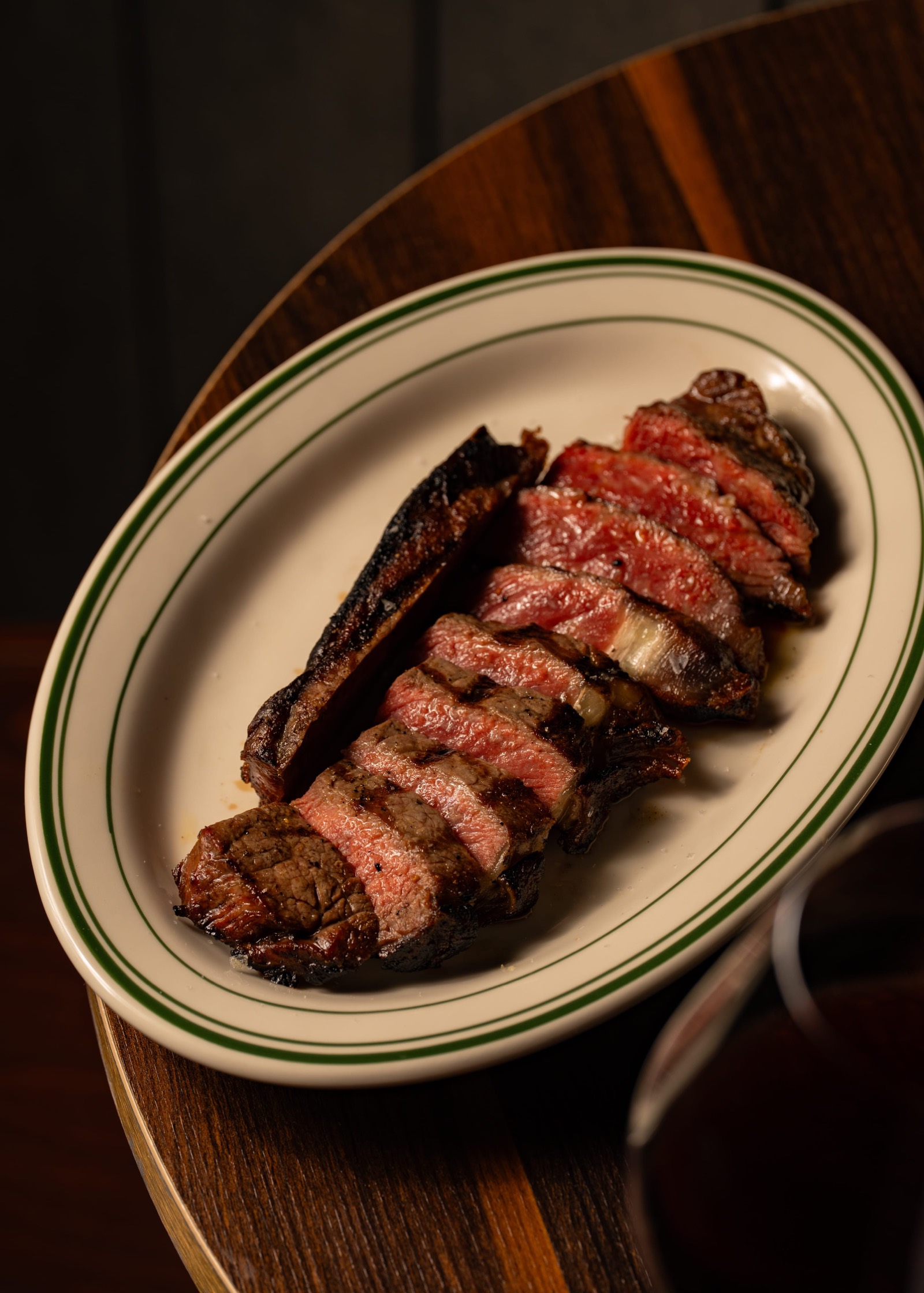 Sliced rump steak on a green-rim plate
