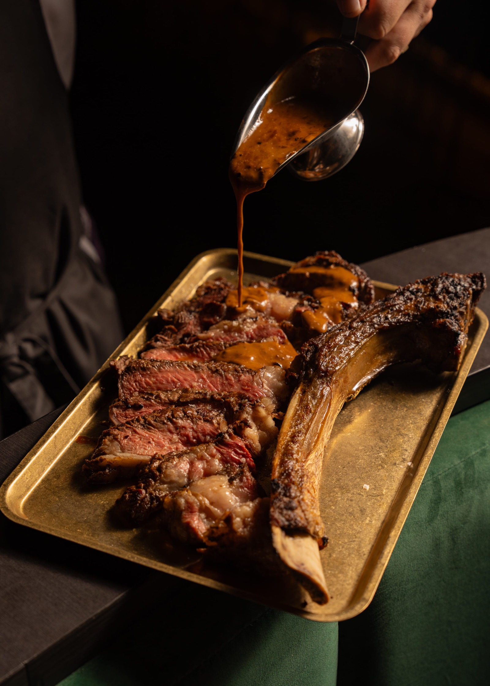 Bordelaise sauce poured over a sliced tomahawk steak