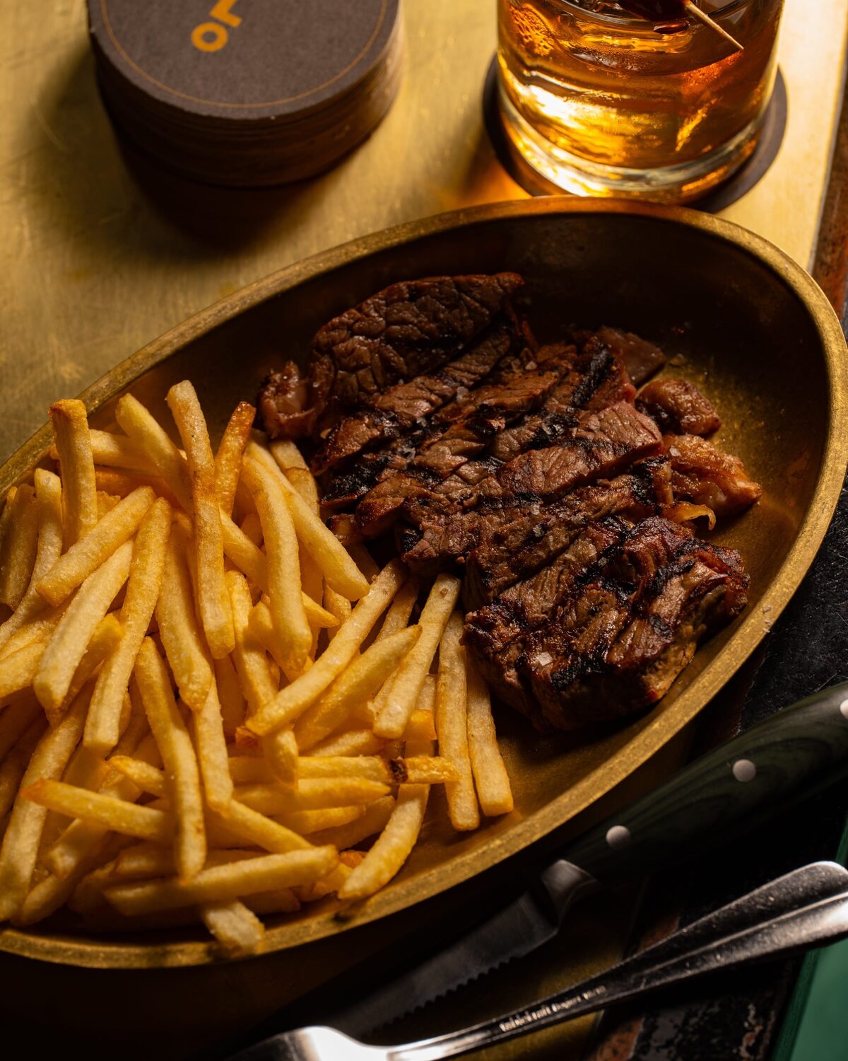 Steak and fries with a drink at Employees Only, now serving lunch Tuesday to Friday
